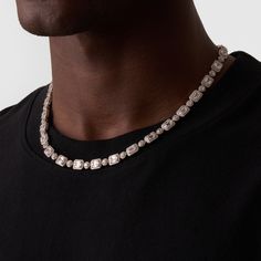 This necklace showcases alternating Baguette and Round Brilliant-Cut Crystal, each framed within a silver 4-claw setting. This design not only protects the stones but also maximises their ability to reflect natural light like never before. Each clear crystal is surrounded by a cluster of the coldest, AAA-grade stones—handpicked and precision-set to deliver a shine that rivals even the finest diamonds. The coupled links rest effortlessly along your neckline, while its snap-proof clasp and scratch Luxury Silver Baguette Cut Diamond Necklace, Luxury Silver Baguette-cut Diamond Necklace, Timeless Silver Tennis Necklace With 17 Jewels, Timeless Silver Jewelry With Sparkling Stones, Timeless Iced Out Jewelry For Anniversary, Silver Baguette Cut Diamond Necklace, Silver Cubic Zirconia Necklace With Stones, Classic Silver Jewelry With Stones, Silver Iced Out Diamond Necklace Fine Jewelry