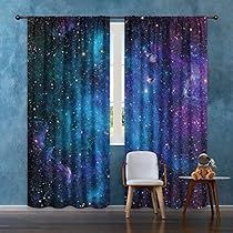 a room with a chair, table and window covered in curtains that look like stars