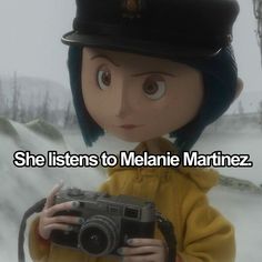 a person holding a camera and wearing a hat with the caption she listens to melanie marinez