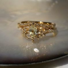 a yellow diamond ring sitting on top of a shell