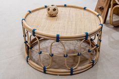 a table with a soccer ball sitting on it's top and blue tape around the edge