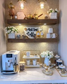 the coffee bar is decorated with gold and white decor