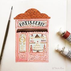 a drawing of a pastry shop with paint and markers on the table next to it