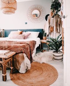 a bed room with a neatly made bed and lots of decorations on the wall above it