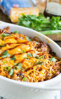 a casserole dish with meat, cheese and green onions