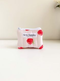 Our small quilted makeup pouch is handmade using cotton fabric.  It offers function and style and fits perfectly in your handbag while you're on the go. We recommend using it for makeup, coins and business cards and other small accessories. Featuring red strawberries on pink cotton fabric, white zipper pull and beige cotton lining. It is perfect for travel and everyday use. Dimensions of product  11cm width x 9cm height Care instructions Hand wash recommended Trendy Coin Purse With Zipper Pocket As Gift, Quilted Pouch Cosmetic Bag Gift, Quilted Cosmetic Pouch Bag As Gift, Quilted Pouch Cosmetic Bag As Gift, Quilted Pouch Cosmetic Bag, Pink Quilted Bag For Gift, Quilted Pouch Bag For Gift, Fabric Bags With Zipper Pouch For Gift, Fabric Bags With Zipper Pouch As Gift