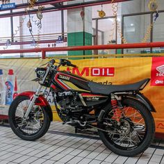 a motorcycle is parked in front of a sign