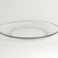 an empty glass plate sitting on top of a white table