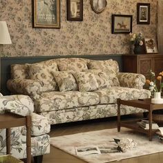 a living room filled with furniture and pictures on the wall