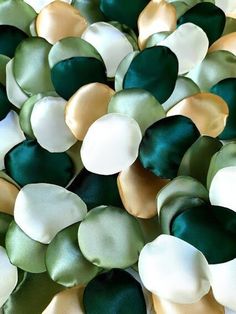 green, white and gold beads are arranged together