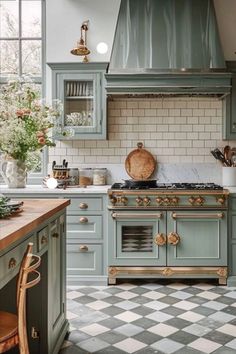 a kitchen with green cabinets and checkered flooring, an oven in the center