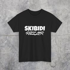 Step up your meme game with our 'Skibidi Rizzler' T-shirt!  Featuring the catchy and humorous text, this shirt is perfect for those who love to stay on top of internet trends and viral memes. Whether you're out with friends or just enjoying a day off, this tee adds a playful touch to any outfit. Show off your meme savvy and bring a smile to everyone's face with this quirky and fun shirt! Crafted from 100% cotton, this shirt promises unparalleled comfort and durability. Whether you're out conquer Inappropriate Shirts, Silly Clothes, Silly Shirt, Funky Hats, Normal Clothes, Fun Shirt, Weird Shirts, Fire Fits, Funny Shirt