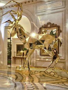 a large gold horse statue sitting in the middle of a room