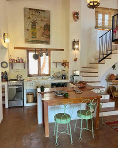 a kitchen and dining area with stairs leading up to the second floor