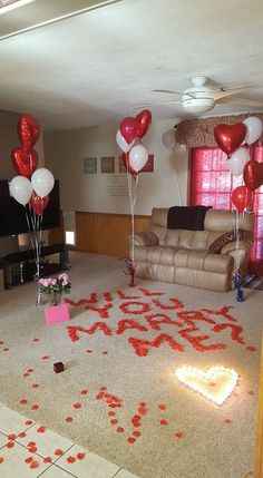 a living room decorated for valentine's day with balloons and confetti on the floor