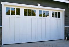 a white garage door on a gray house