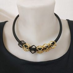 "An elegant black and gold geometric necklace on black silicon cord. Unique geometric elements and a toggle clasp. This necklace will upgrade any outfit! You can wear it with a plain white t-shirt and your favorite pair of jeans all day long at work, or with a small black dress on the evening when you celebrate life! Find out which way you like it the best! * * * * * * * * * * * Materials: 0.24\"/6m\"m thick black silicon cord gold plated pewter gold plated toggle clasp & elements Toggle cla Adjustable Geometric Black Jewelry, Adjustable Black Geometric Jewelry, Modern Black Geometric Necklace, Gold Geometric Necklace, Plain White T's, Plain White T Shirt, Geometric Elements, Special Necklace, Small Black Dress