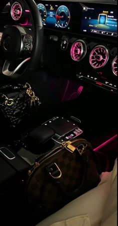 the interior of a car with dashboard lights, gauges and handbags on display