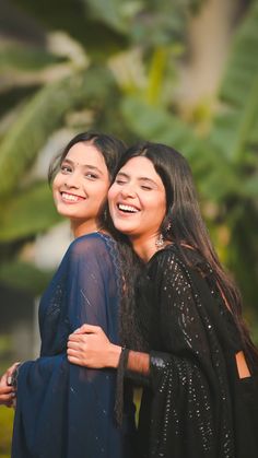 two women standing next to each other smiling