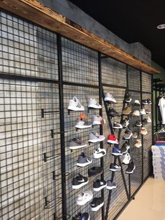 there are many pairs of shoes on display in the store's shoe rack area