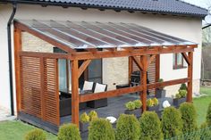 a house with a covered patio in the front and side yard area next to it