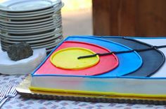 there is a cake that looks like a record player on the table next to some plates