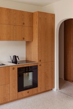 a kitchen with wooden cabinets and an oven