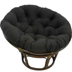 a round chair with black cushions on it