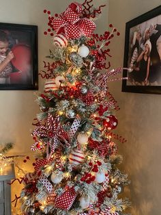 a christmas tree decorated with red, white and silver ornaments