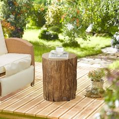 a wooden table sitting on top of a wooden deck next to a chair and ottoman