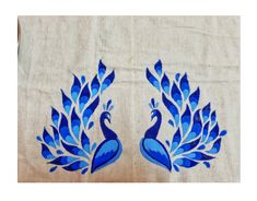 two blue peacocks are on a white linen material with an intricate design in the middle