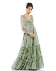 Romantic maxi dress with a pleated bodice and faux-wrap v-neckline, tiered floor-length skirt, and sheer long sleeves. Mac Duggal 100% Polyester Back Zipper V-Neck Long Sleeves Approx. 62.5" from top of shoulder to bottom hem Style #67864 Ombre Gown, Tiered Gown, Romantic Maxi Dress, Mac Duggal Dresses, Pleated Bodice, Mac Duggal, Chiffon Gown, A Line Gown, Dress Silhouette