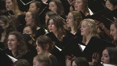 a large group of women singing in choir