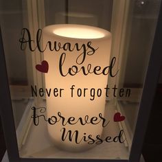 a lighted candle that says, always loved never forgotten forever missed