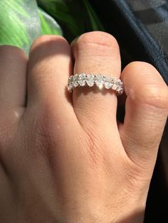 a woman's hand with a diamond ring on it