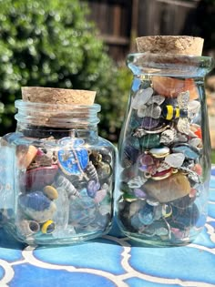 two glass jars filled with different types of toys