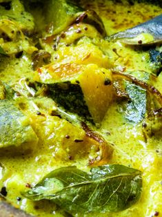 a close up view of some food in a bowl with spinach and other vegetables