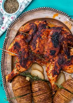 grilled chicken with potatoes and herbs on a platter