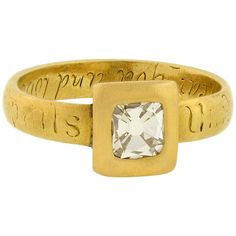 A very unusual and special diamond ring from the Georgian (ca1820) era! This rare single stone piece features a lovely and romantic design crafted in vibrant 18kt yellow gold. A sparkling old Tablet Cut diamond rests at the center, held within a wide, squared bezel frame. The diamond weighs approximately 0.68ct and the unique cut sparkles beautifully within the open-backed setting. The squared centerpiece rests at the center of a solid gold band which has a special inscription that carries aroun Georgian Table, Diamond Centerpiece, Ancient Jewels, Georgian Jewelry, Buckle Ring, Solid Gold Band, Gold Table, Romantic Design, Ancient Jewelry