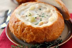 bread bowl filled with soup on top of a plate