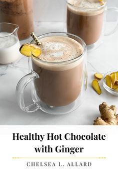 two mugs filled with hot chocolate and topped with ginger