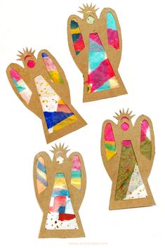 four pieces of paper cut out to look like mitts with different colors and shapes