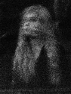 a blurry photo of a woman with long hair