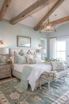 a bedroom with a bed, dresser and chandelier in the middle of it