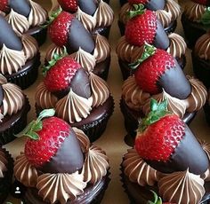 chocolate cupcakes with strawberries on top are lined up in rows and ready to be eaten