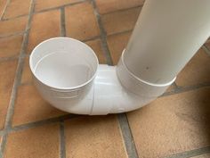 a white toilet sitting on top of a tiled floor