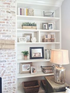 a living room filled with lots of white shelves