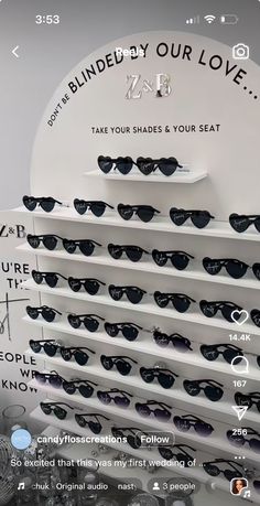 the display case is full of sunglasses and has an ad on it that reads, i'm blinded by your love