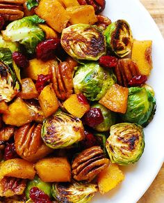 brussel sprouts, brussels sprouts, and pecans in a white bowl