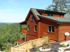 a log cabin sits on top of a mountain